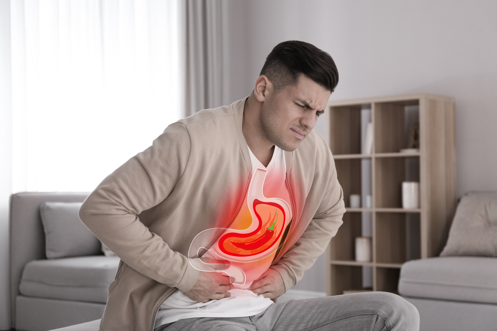Man Suffering from Heartburn at Home. Stomach with Hot Chili Pepper Symbolizing Acid Indigestion, Illustration